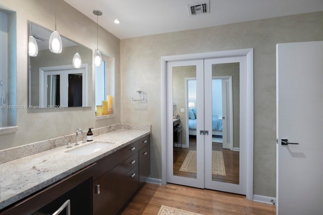 11900 SW 72nd Pl, Pinecrest, FL 33156 - ensuite bathroom featuring vanity, wood finished floors, and french doors