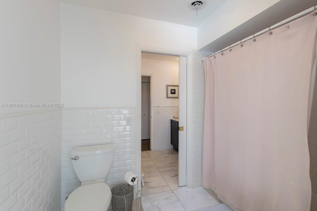 11900 SW 72nd Pl, Pinecrest, FL 33156 - bathroom featuring wainscoting, tile walls, marble look tiles, a fireplace, and curtained shower
