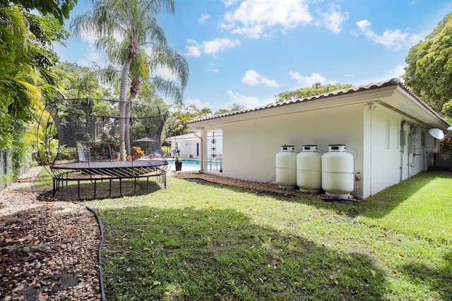11900 SW 72nd Pl, Pinecrest, FL 33156 - view of yard featuring a trampoline and an outdoor pool