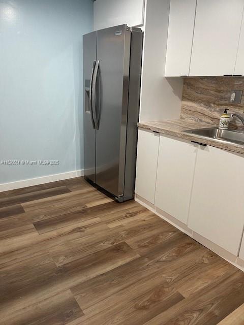 1475 NE 125th Ter Unit 614K, North Miami, FL 33161 - kitchen featuring stainless steel refrigerator with ice dispenser, white cabinetry, wood finished floors, and light countertops