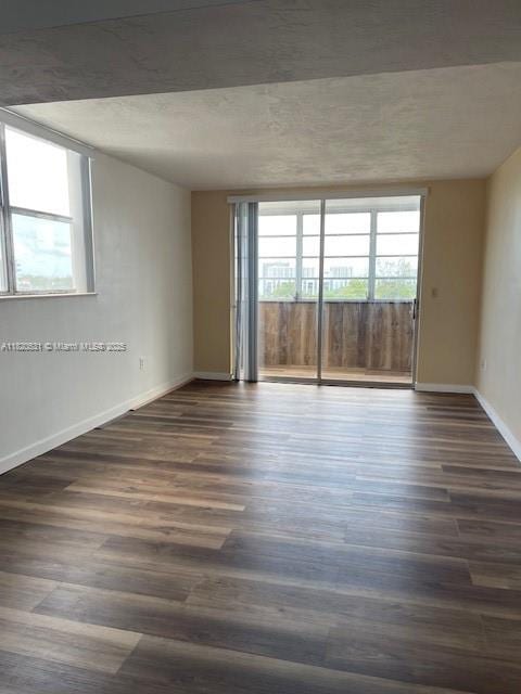 1475 NE 125th Ter Unit 614K, North Miami, FL 33161 - spare room with dark wood finished floors and baseboards