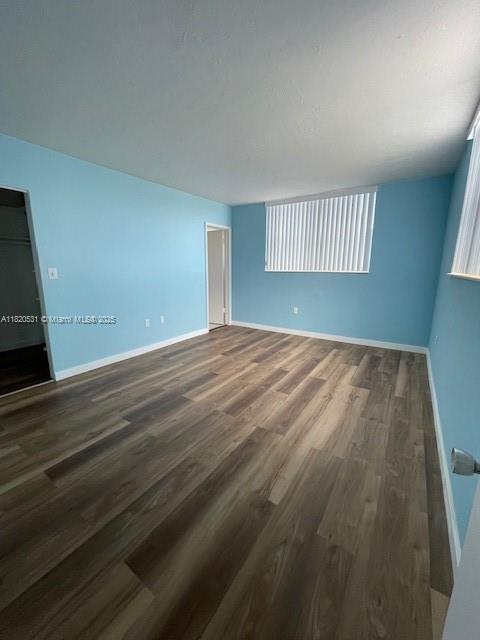 1475 NE 125th Ter Unit 614K, North Miami, FL 33161 - unfurnished room featuring wood finished floors and baseboards