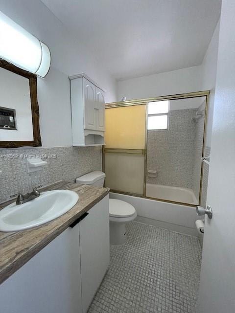 1475 NE 125th Ter Unit 614K, North Miami, FL 33161 - bathroom featuring vanity, shower / bath combination with glass door, backsplash, and tile patterned floors