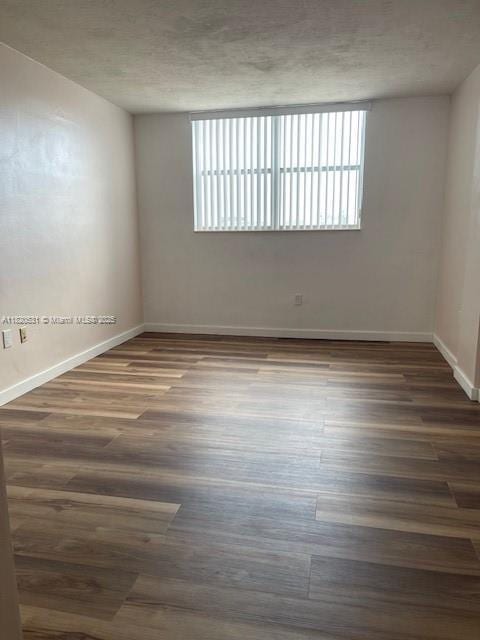 1475 NE 125th Ter Unit 614K, North Miami, FL 33161 - empty room featuring dark wood-style floors and a textured ceiling