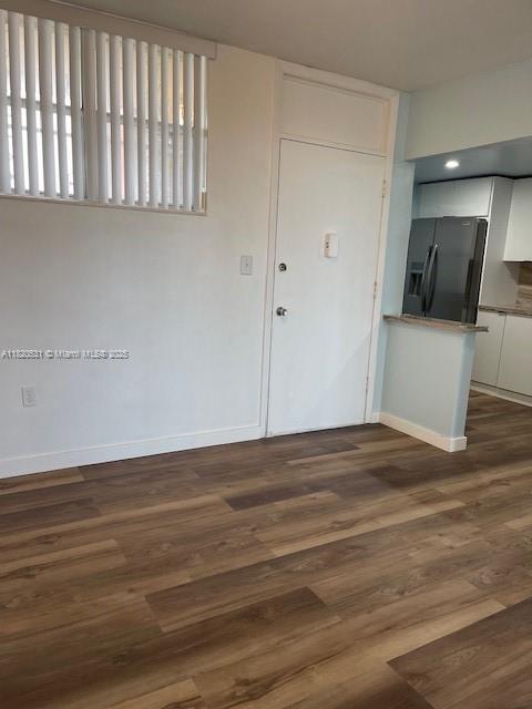 1475 NE 125th Ter Unit 614K, North Miami, FL 33161 - entryway with baseboards and dark wood-type flooring