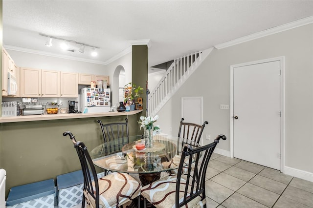 12006 SW 2nd St, Pembroke Pines, FL 33025 - dining room featuring track lighting, ornamental molding, light tile patterned flooring, arched walkways, and stairway