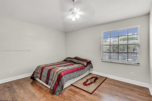 12006 SW 2nd St, Pembroke Pines, FL 33025 - bedroom featuring wood finished floors, a textured ceiling, and ceiling fan