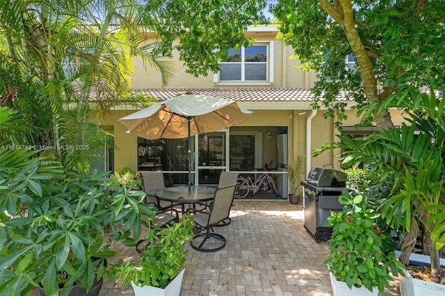 12006 SW 2nd St, Pembroke Pines, FL 33025 - back of property with stucco siding, a patio, and outdoor dining space