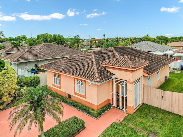 19730 NW 78th Path, Hialeah, FL 33015 - view of front of property with a gate, stucco siding, and a tile roof