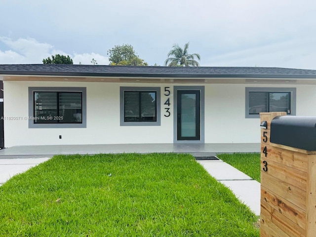 543 E 61st St, Hialeah, FL 33013 - ranch-style house with a front lawn, stucco siding, a shingled roof, and covered porch