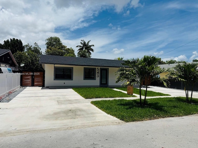 543 E 61st St, Hialeah, FL 33013 - single story home with stucco siding, roof with shingles, and concrete driveway