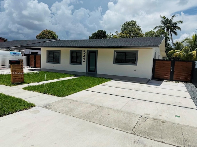 543 E 61st St, Hialeah, FL 33013 - single story home featuring a gate, stucco siding, a shingled roof, and driveway
