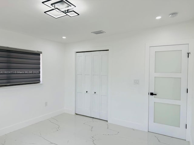 543 E 61st St, Hialeah, FL 33013 - unfurnished bedroom featuring light marble finish floors, recessed lighting, and a closet
