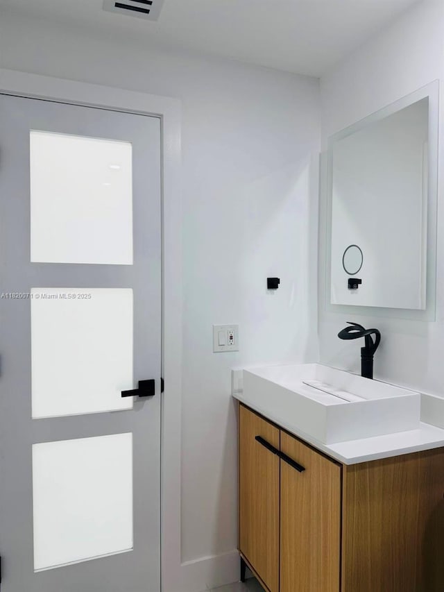 543 E 61st St, Hialeah, FL 33013 - bathroom with vanity and baseboards