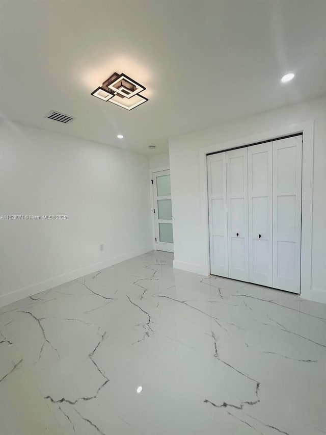 543 E 61st St, Hialeah, FL 33013 - unfurnished bedroom with recessed lighting, light marble finish flooring, and a closet