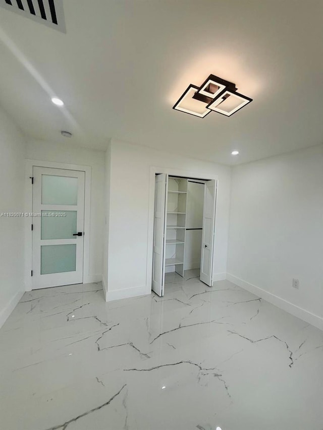 543 E 61st St, Hialeah, FL 33013 - unfurnished bedroom featuring light marble finish flooring, recessed lighting, and a closet