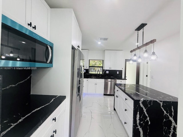 543 E 61st St, Hialeah, FL 33013 - kitchen with stainless steel appliances, light marble finish floors, white cabinets, and pendant lighting