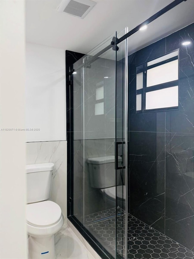 543 E 61st St, Hialeah, FL 33013 - full bathroom with tile walls, marble finish flooring, and a shower stall