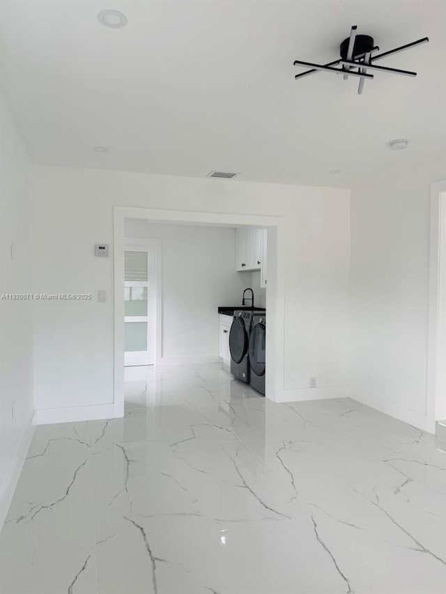 543 E 61st St, Hialeah, FL 33013 - unfurnished room featuring light marble finish floors and washer / clothes dryer