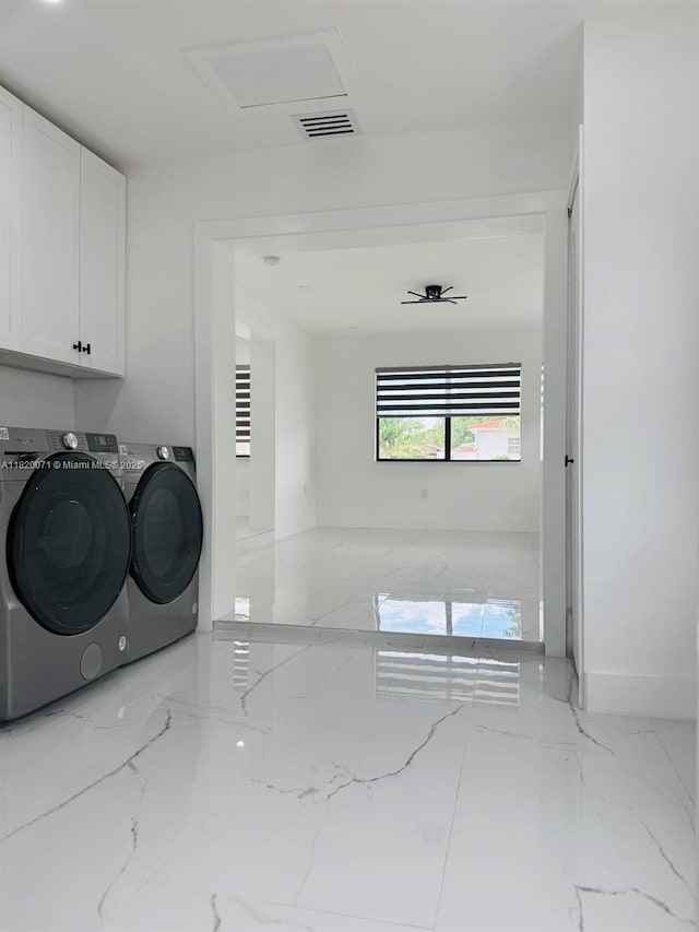 543 E 61st St, Hialeah, FL 33013 - laundry room with cabinet space, washer and clothes dryer, marble tiled floors, and attic access
