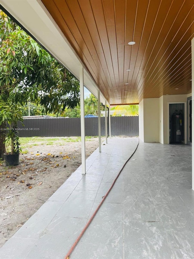 543 E 61st St, Hialeah, FL 33013 - fenced backyard with a patio area and water heater