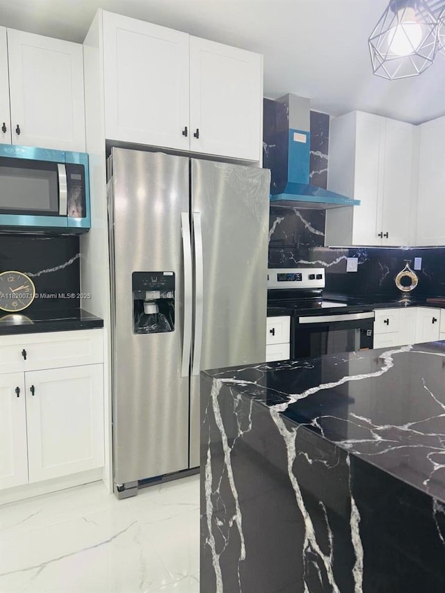 543 E 61st St, Hialeah, FL 33013 - kitchen featuring stainless steel appliances, wall chimney exhaust hood, tasteful backsplash, light marble finish flooring, and white cabinetry