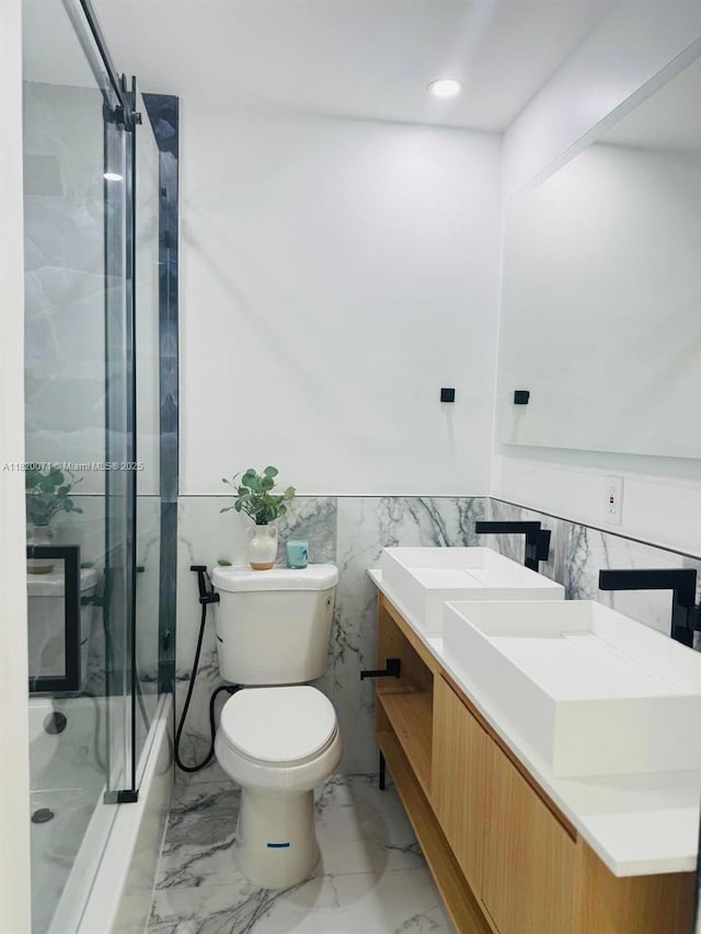 543 E 61st St, Hialeah, FL 33013 - bathroom with marble finish flooring, enclosed tub / shower combo, vanity, tile walls, and a wainscoted wall