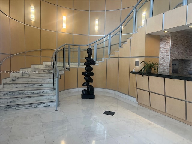 6770 Indian Creek Dr Unit 6D, Miami Beach, FL 33141 - staircase with marble finish floors and a high ceiling