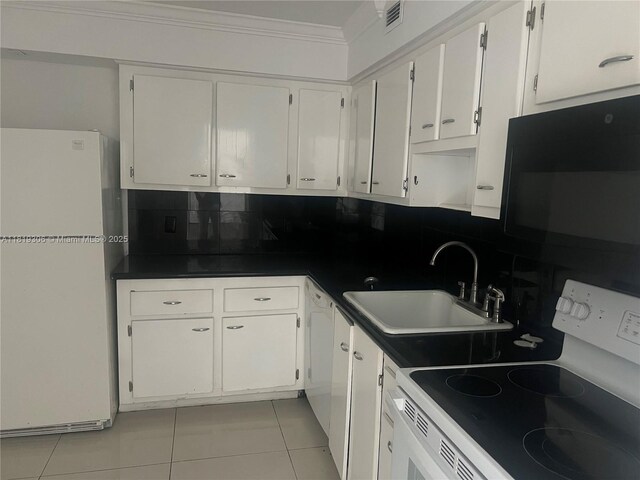6770 Indian Creek Dr Unit 6D, Miami Beach, FL 33141 - kitchen featuring white appliances, backsplash, light tile patterned floors, white cabinetry, and ornamental molding