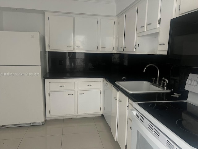 6770 Indian Creek Dr Unit 6D, Miami Beach, FL 33141 - kitchen with white appliances, backsplash, light tile patterned flooring, and white cabinets