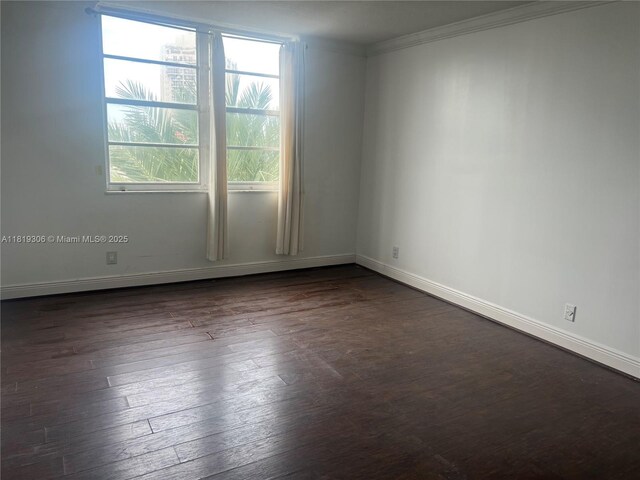 6770 Indian Creek Dr Unit 6D, Miami Beach, FL 33141 - spare room featuring healthy amount of natural light, dark wood finished floors, and ornamental molding