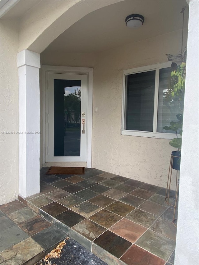 10090 NW 57th St, Doral, FL 33178 - doorway to property with stucco siding