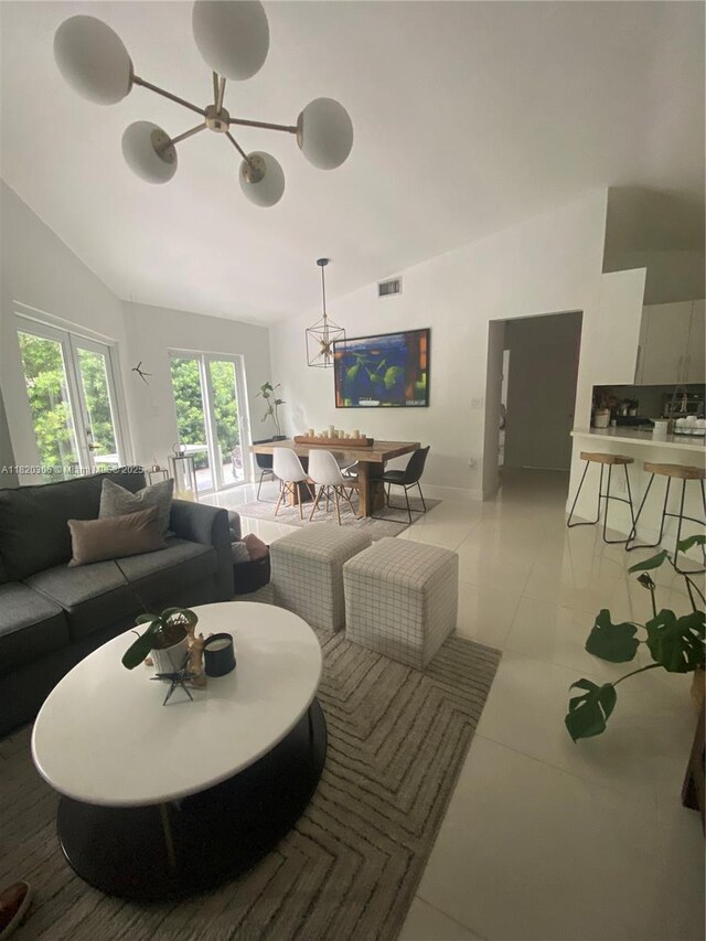 10090 NW 57th St, Doral, FL 33178 - living room with vaulted ceiling, a chandelier, and light tile patterned floors