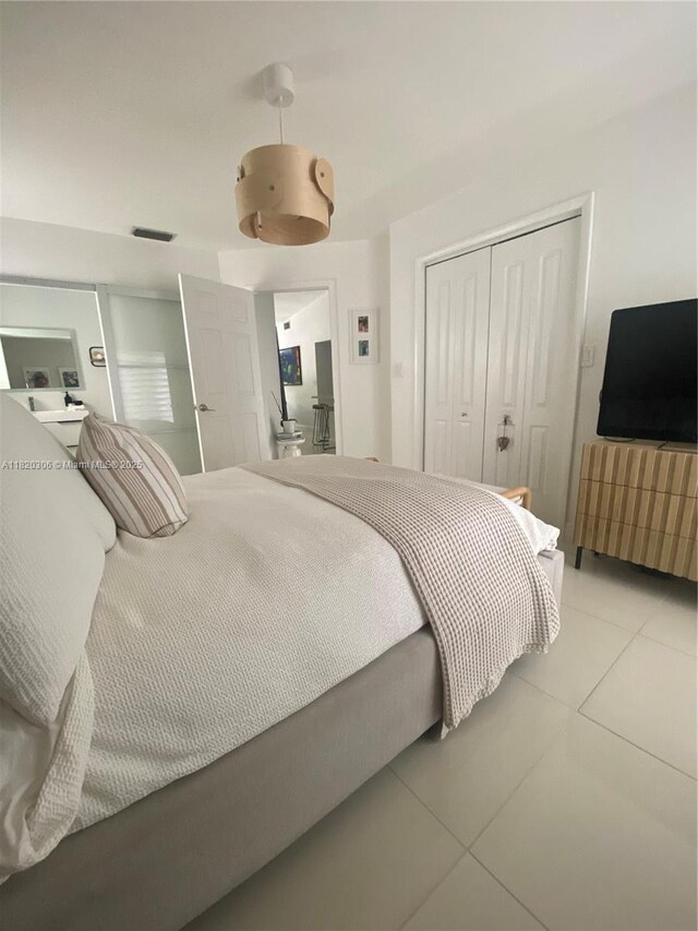 10090 NW 57th St, Doral, FL 33178 - bedroom with light tile patterned floors and a closet
