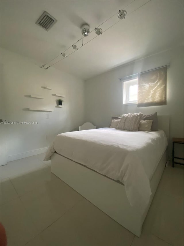 10090 NW 57th St, Doral, FL 33178 - bedroom with light tile patterned floors and baseboards
