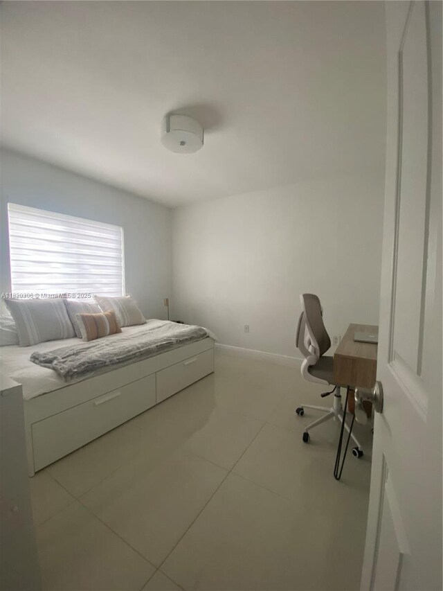 10090 NW 57th St, Doral, FL 33178 - tiled bedroom featuring baseboards