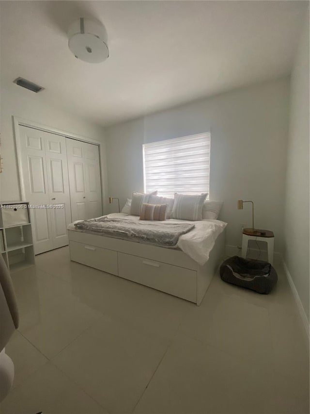 10090 NW 57th St, Doral, FL 33178 - bedroom featuring light tile patterned flooring and a closet