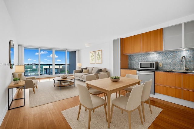 100 Bayview Dr Unit 1223, Sunny Isles Beach, FL 33160 - dining area with a wall of windows and light wood finished floors