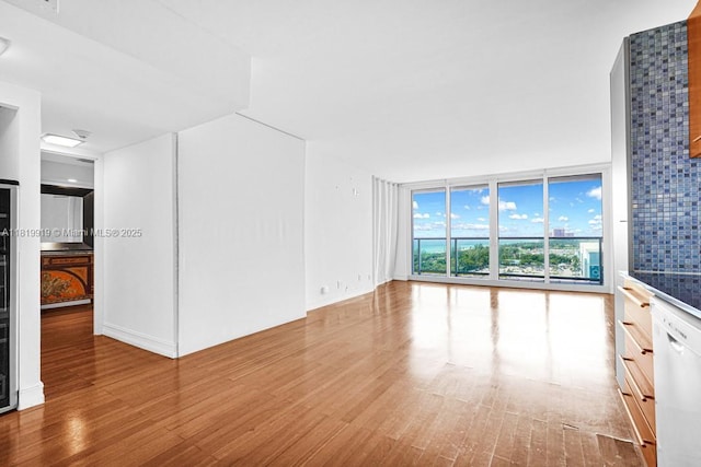 100 Bayview Dr Unit 1223, Sunny Isles Beach, FL 33160 - unfurnished living room featuring wood finished floors and floor to ceiling windows
