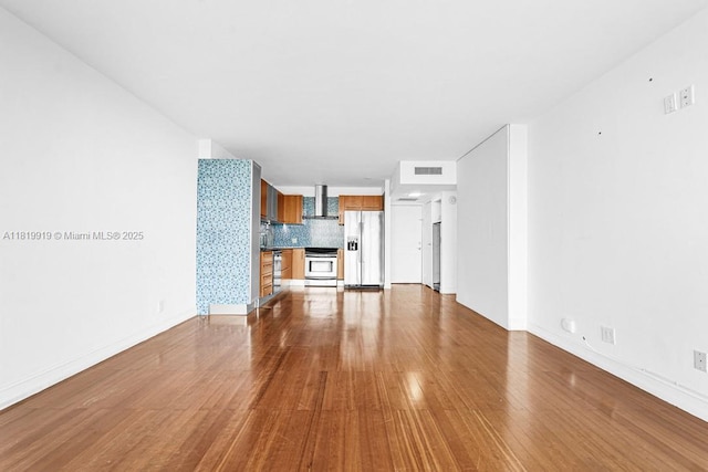 100 Bayview Dr Unit 1223, Sunny Isles Beach, FL 33160 - unfurnished living room featuring wood finished floors and baseboards