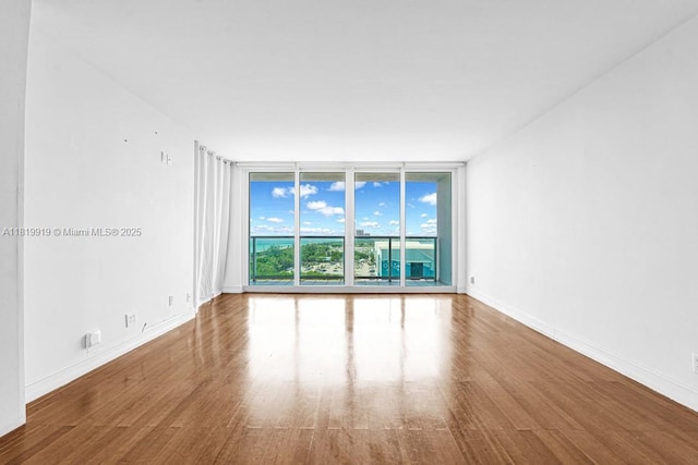 100 Bayview Dr Unit 1223, Sunny Isles Beach, FL 33160 - unfurnished room with a wall of windows and wood finished floors