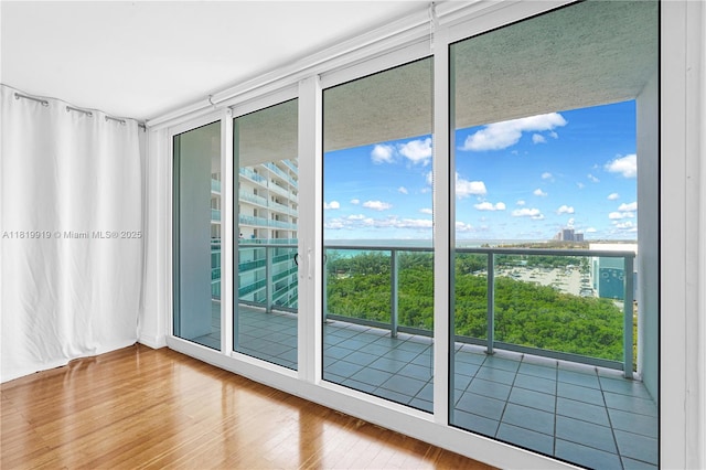 100 Bayview Dr Unit 1223, Sunny Isles Beach, FL 33160 - spare room with wood finished floors and floor to ceiling windows