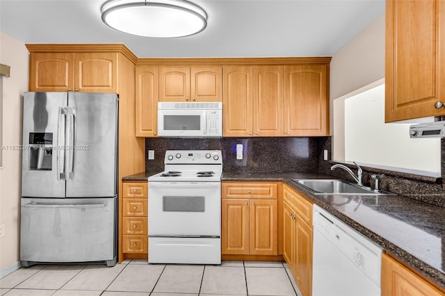 7801 Abbott Ave Unit 307, Miami Beach, FL 33141 - kitchen featuring white appliances, light tile patterned flooring, dark stone countertops, and decorative backsplash
