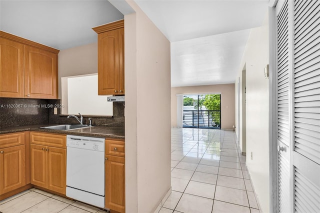 7801 Abbott Ave Unit 307, Miami Beach, FL 33141 - kitchen featuring white dishwasher, light tile patterned flooring, tasteful backsplash, and dark countertops