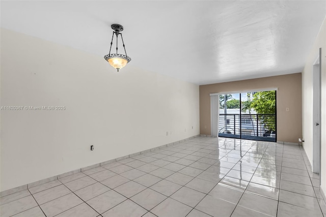 7801 Abbott Ave Unit 307, Miami Beach, FL 33141 - spare room featuring light tile patterned floors and baseboards