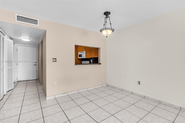 7801 Abbott Ave Unit 307, Miami Beach, FL 33141 - unfurnished room featuring light tile patterned floors and baseboards