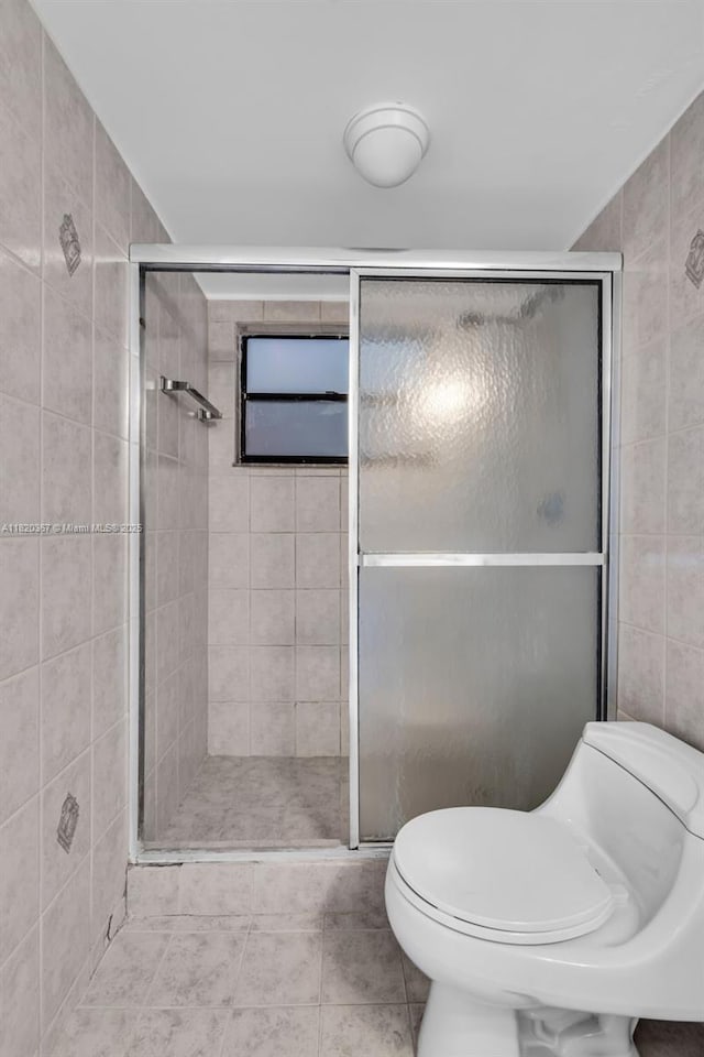 7801 Abbott Ave Unit 307, Miami Beach, FL 33141 - full bath featuring tile walls, a shower stall, and tile patterned floors