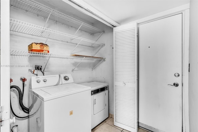 7801 Abbott Ave Unit 307, Miami Beach, FL 33141 - laundry room featuring independent washer and dryer and light tile patterned flooring