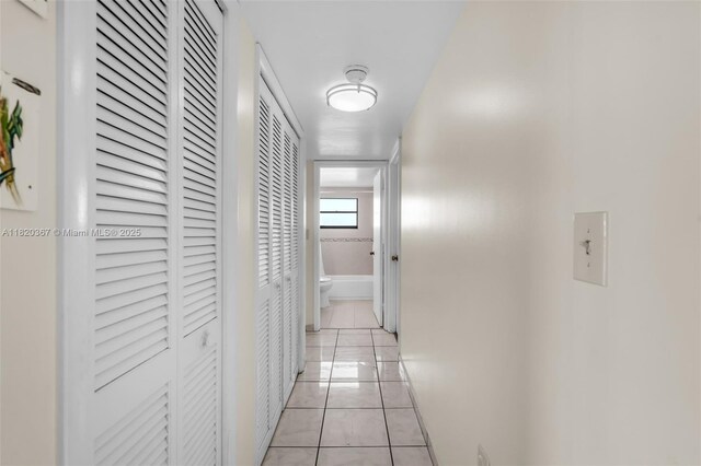 7801 Abbott Ave Unit 307, Miami Beach, FL 33141 - hall with light tile patterned flooring and baseboards