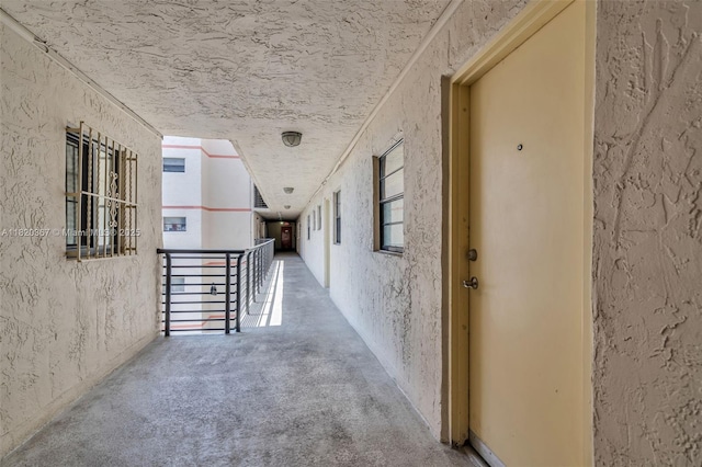 7801 Abbott Ave Unit 307, Miami Beach, FL 33141 - hallway featuring an upstairs landing